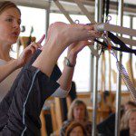 Pilates Mythbusters: Any Fitness Instructor Can Teach Pilates Just by Taking Classes Themselves In the last installment of our quest to dispel common misconceptions about Pilates, we're going to focus on the teachers who are out there working in studios and gyms.Over the past 20 years, the popularity of Pilates has escalated the demand for instructors; thus many "fast Eddie"-type certification programs have sprung up. These inadequate programs teach only the minimum of what one needs to know about the system, and after several weekend training sessions an instructor will emerge with a certificate in hand. Buyers beware! The result is that their future clients will get what the instructors paid for... and that isn't much!In order to be sufficiently trained to teach the classical method (as Joe intended it to be), an instructor will spend a minimum of 600 hours as an apprentice and pass rigorous written and practical exams. Romana Kryzanowska, who started studying with Joseph Pilates in 1941, had a direct hand in educating all of the classical Pilates master teachers, who now pass on Joe's knowledge and legacy to current apprentice instructors -- who will in turn pass it on. This certification process prepares the apprentice to understand the system and teach a classically-based, integrated, systematic workout that utilizes both the mat exercises and the full range of advanced apparatuses. Furthermore, a certified Pilates instructor will be able to advance their clients and challenge them as appropriate to each individual. To that end, apprentices study the history of the method, basic anatomy, and modifications for clients who have special needs. This encompasses the needs of women working out during and after pregnancy, to physical therapy patients who are returning to a regular workout regimen. When taught by a knowledgeable teacher, all clients of all ages and fitness levels will benefit equally.When Pilates is taught as its creator Joseph Pilates intended, the results are dramatic. Satisfied clients delight in their newfound energy, improved posture and leaner, stronger, and even taller bodies. The best part is that it's challenging and fun, so it is anything but mindless and boringAt Dynamic Fitness, Sarasota's Original Pilates Studio, all of the instructors have received classical certification through the guidelines passed on by Romana, and they rejuvenate their knowledge and teaching skills by taking continued education courses with internationally recognized master teachers such as Bob Liekens, who worked personally with Romana. Romana is now retired, but Bob still teaches under her inspiration.Please understand that when you train at Dynamic Fitness, you can be confident you will receive authentic, comprehensive and challenging training in the Pilates method.